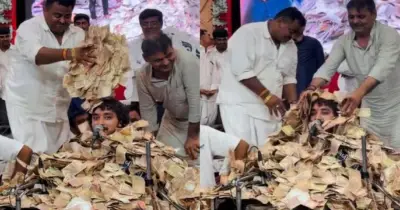 গুজরাটে ভক্তদের নোট বৃষ্টি, টাকার স্তূপে চাপা গায়ক